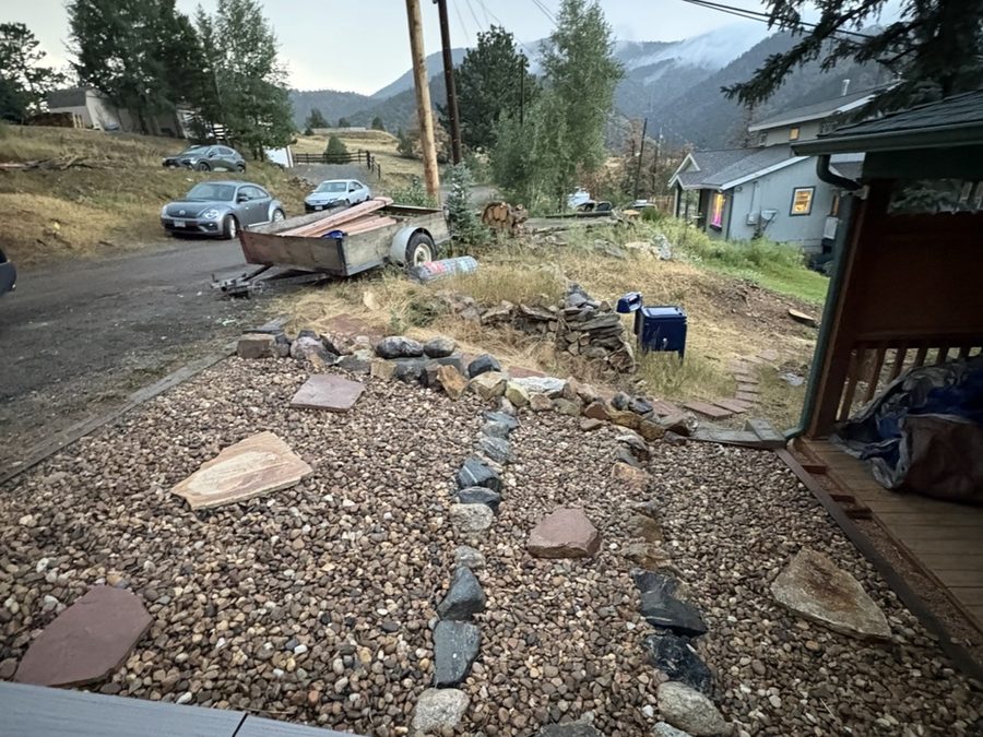 Trailer staged at a mountain-community property for a cleanup job